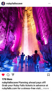 People in the Ruby Falls cave with purple lighting